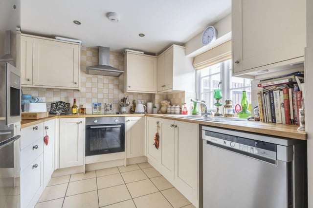 The tiled kitchen features all of the white goods appliances.