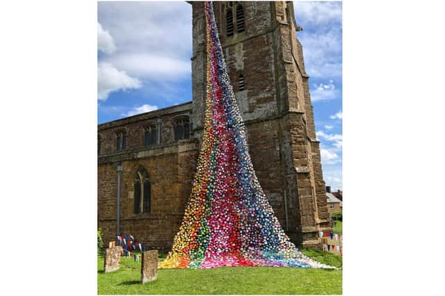 A photo of the flower tower consisting of more than 4,300 handmade flowers at All Saints Church in the village of Middleton Cheney. (photo by Georgina Campion)