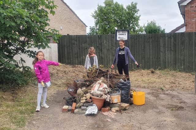 Children of Lidsey Road with the pile of fly-tipped rubbish they collected.