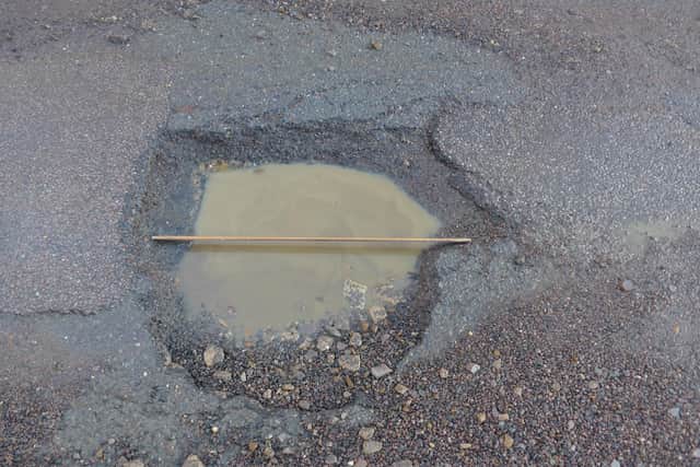 The largest pothole on Hopcraft Lane put in perspective with a one-metre rule