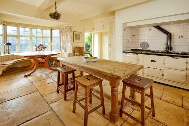 The kitchen is positioned in the centre of the house and has impressive flagstone floors, and an AGA oven.