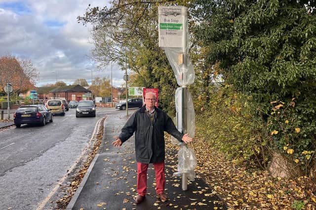 Cllr Kieron Mallon in front of the new bus stop on Hightown Road.