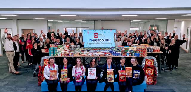 Staff at Neighbourly in Brackley with the company's donation to the local food bank.