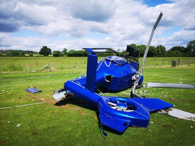 The crashed helicopter pictured by fire crews on Saturday