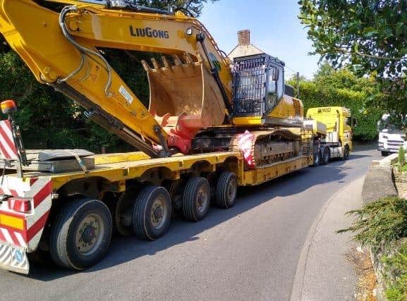 A low loader meets a lorry at the Farthinghoe pinch point demonstrating the inadequacy of the road for very large traffic