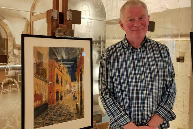 Dave Watts with his pastel picture of a street in Seville.