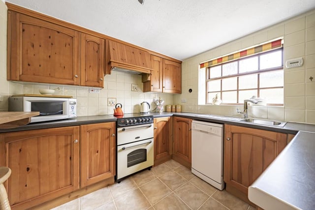 The kitchen comes fitted with a  breakfast bar and oven alongside selected white goods.