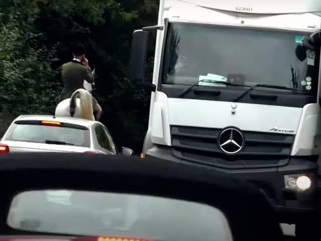 Members of the Warwickshire Hunt have been filmed causing traffic disruption on a high crash risk section of the busy Fosse Way in Warwickshire. This rider was on his phone as traffic queued behind him.