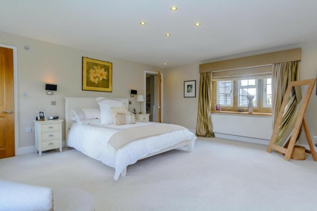 The master bedroom has a fitted wardrobe space and a door leads to a stunning en-suite bathroom.