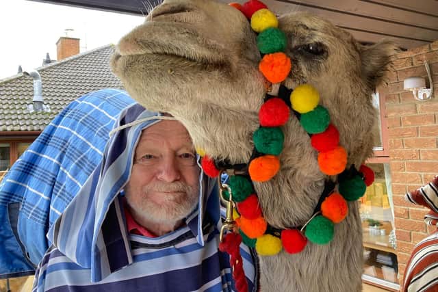 Lake House resident John Webb gets close to Kokoso the camel during the Nativity