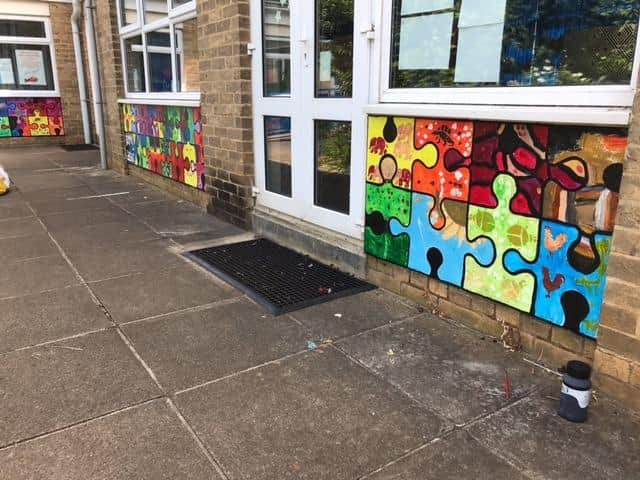 The project, called 'we fit together', is made up of over 300 jigsaw pieces on the walls of Christopher Rawlins Primary School in Adderbury