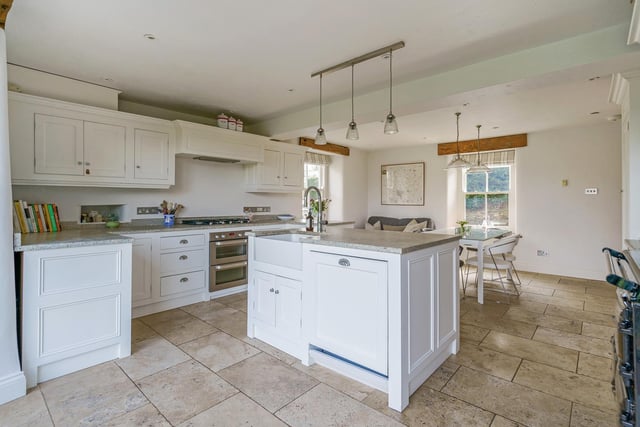 The kitchen also has a work island, gas Aga, separate gas hob and double stainless steel oven.