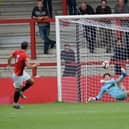 Banbury United's Jack Harding saves a penalty during his team's shoot-out success at FC United of Manchester. Picture by Julie Hawkins