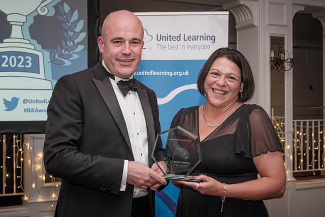 Hanwell Fields staff member Alison Gordon receiving her award from chief executive of United Learning Sir Jon Coles.