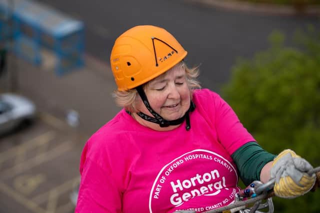 Pippa Parnell conquers her nerves and abseils down the side of the JR building. Picture by Joe Baker / Oxford Hospitals Charity