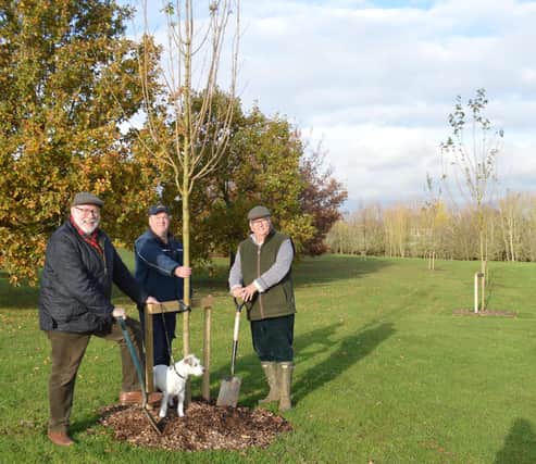 Cllr Kieron Mallon (left) and Cllr Martin Phillips (right) and dog Meg finish planting the last tree at Crouch Hill Open Space with park ranger Ian Harper
