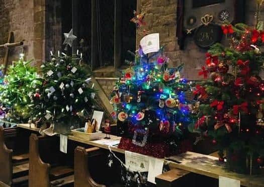 Brightly decorated trees at a previous Adderbury Christmas Tree Festival