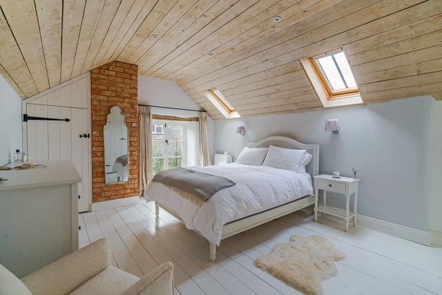The main bedroom was the former granary, and has wood panelled ceiling, ample cupboards and a good sized ensuite with double wash basins.