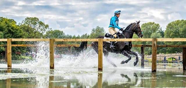 Aynho's Izzy Taylor gallops across the lake on a previous visit to the Blenheim Horse Trials