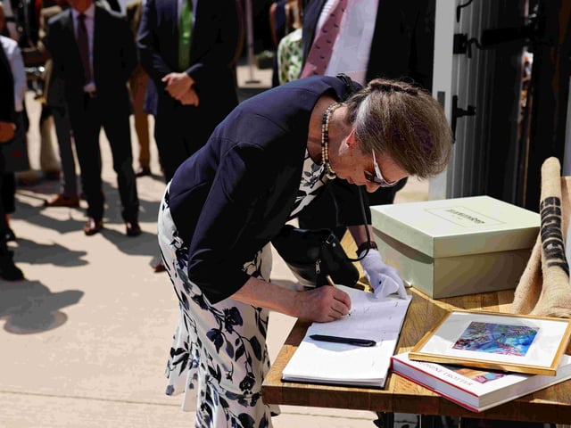 Her Royal Highness The Princess Royal signing the brewery’s visitor book.