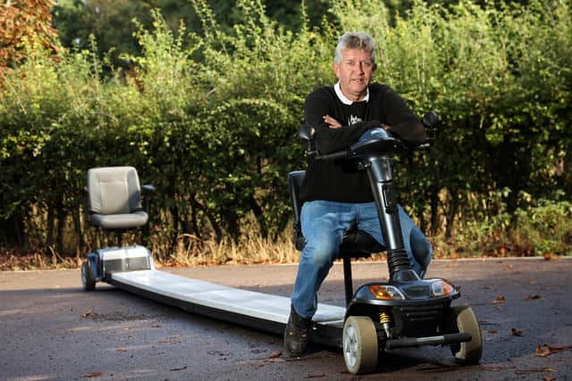 Kevin Nicks is pictured on last year's invention, the longest scooter - as long as an elephant