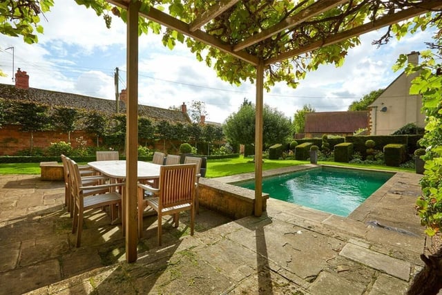 The house has a flagstone paved terrace with pergola, perfect for entertaining guests.