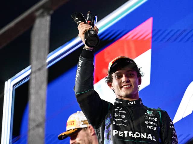 Kimi Antonelli celebrates his third-placed finish at the Singapore Grand Prix. (Photo by ANTHONY WALLACE / AFP via Getty Images)