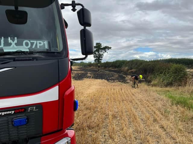 Firefighters complete inspections after putting out the blaze on farmland