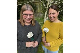 Katharine House team members Sally Brooks and Sue Blank with the new roses for 2024.