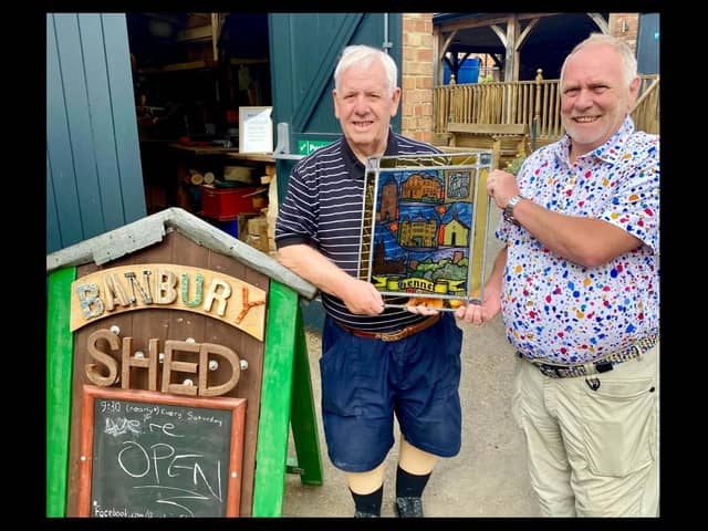 John Donaldson, chairman of the Banbury and District Twinning Association Chairman alongside Scotty of the Banbury shed group with the glass art piece. Credit Banburyshire Info