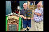 John Donaldson, chairman of the Banbury and District Twinning Association Chairman alongside Scotty of the Banbury shed group with the glass art piece. Credit Banburyshire Info
