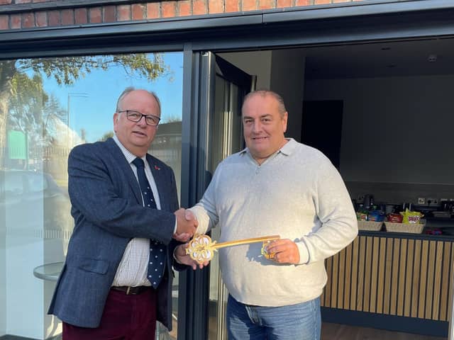 Cllr Martin Phillips handing over the keys to the new café in People's Park to Carl Fox.
