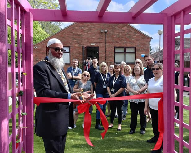 Banbury Town Mayor Fiaz Ahmed cuts the ribbon to officially open the Grimsbury Community Centre's new garden.