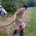 A Warwickshire Hunt servant removes the dead body of the fox at Monday's hunt at Idlicote