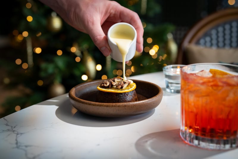 18-month matured Christmas pudding topped with fresh orange and walnuts, served with warm brandy sauce