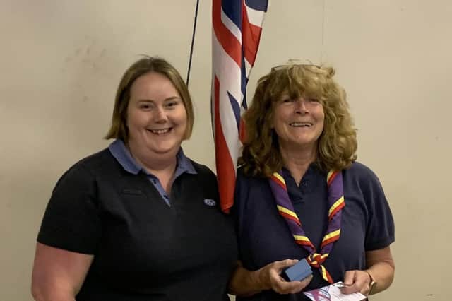 At last week's 1st Bodicote Guides enrolment evening, District Commissioner Emily West presented Wendy Stephenson with her 30 year award.