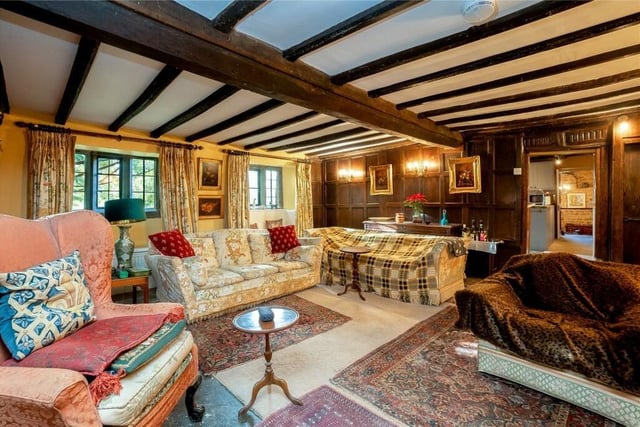 The house has retained many of its original features, including exposed beam ceilings and attractive wood-panelled walls.