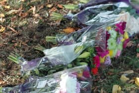 Flowers left at the scene of the crash in which a young woman died