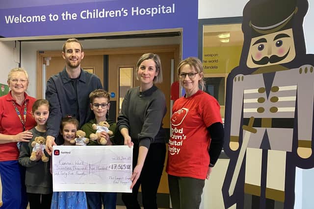 The Haggar family hands the giant cheque to Sheila Caldecott, senior play specialist and Claire Newton from Oxford Hospitals Charity.