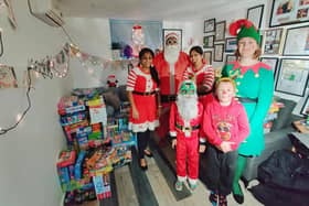 Prabhu and his family in their roles as the Santa Claus family alongside neighbour Daisy Hone who directed traffic as a helpful elf.