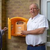 Cllr Phillips (right) and Paul Almond, the town council’s Environment Officer, examine the defib at Horton View sportsground.