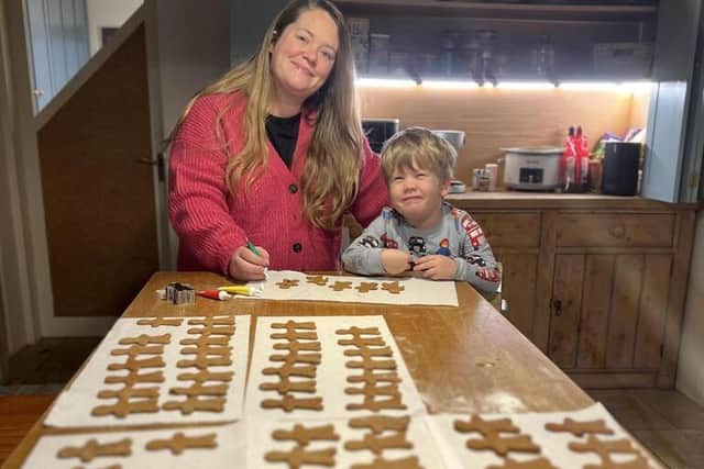 Laura Sharpe and son George are pictured with some of their 500 gingerbread men