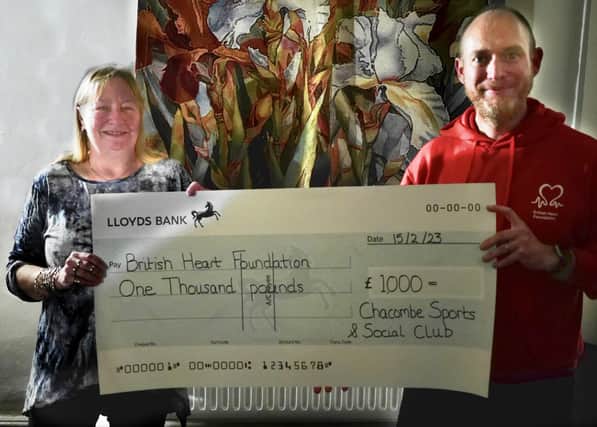 The Sports and Social Club's Lorna Fyfe presenting a cheque to Jon Frost from the British Health Foundation.