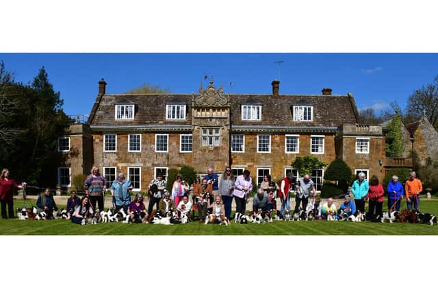 Nearly 100 rare breed King Charles Spaniels lined the front of historic Chacombe Priory to honour the forthcoming Coronation of King Charles III. Photo by Noah Tarabad.