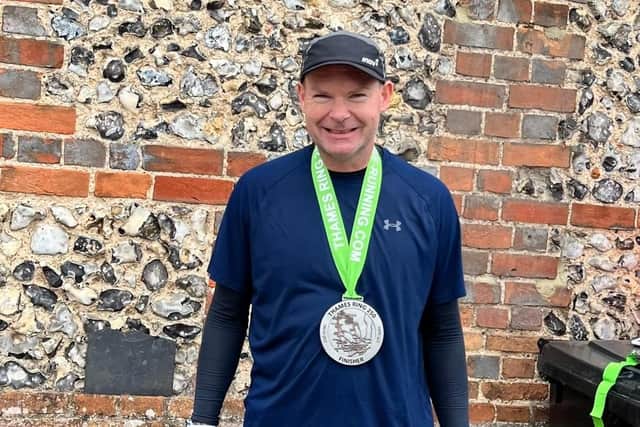 An exhausted Steve poses with his medal after completing one of the country's toughest races.