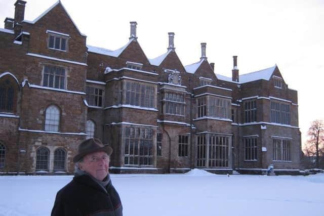 Lord Saye and Sele outside Broughton Castle in the snow