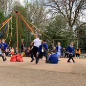 Children from Wroxton Primary School take part in a Maypole Dance as part of the May Day activities at the school (photo from the school)