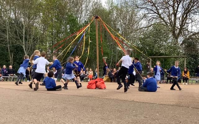 Children from Wroxton Primary School take part in a Maypole Dance as part of the May Day activities at the school (photo from the school)
