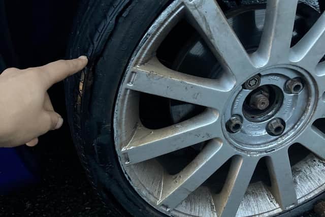 A motorist's tyre, split by crashing into the deep pothole at Clifton