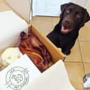 A happy customer with one of LCA's dog treat boxes.